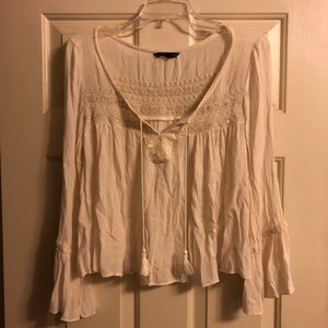 Cream colored flowy blouse with tassels